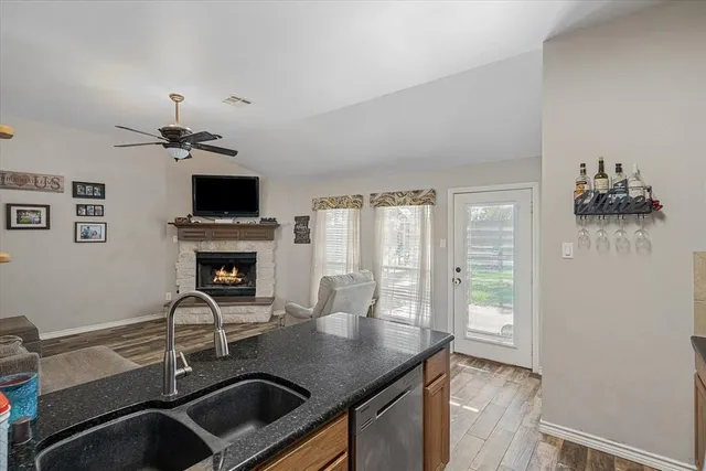 a kitchen with a sink appliances and a window