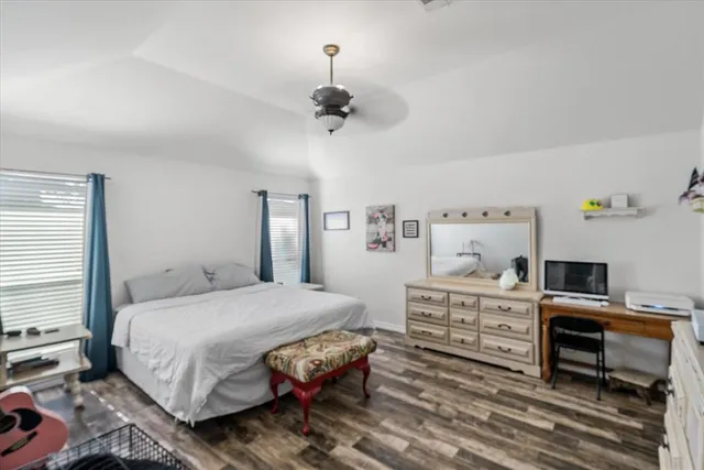 a bedroom with a bed and a desk