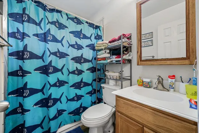 a bathroom with a toilet sink and mirror