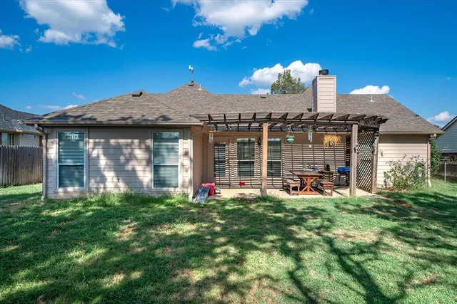 a front view of a house with swimming pool and porch with furniture