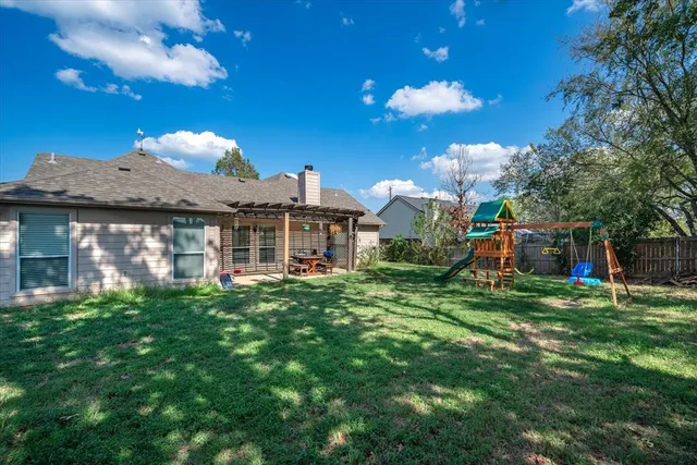 a front view of a house with a yard table and chairs