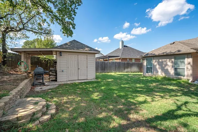 a front view of a house with a garden and lake view