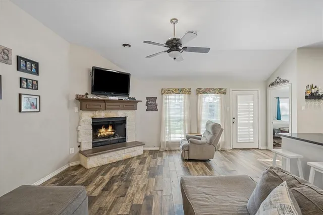 a living room with furniture a flat screen tv and a fireplace