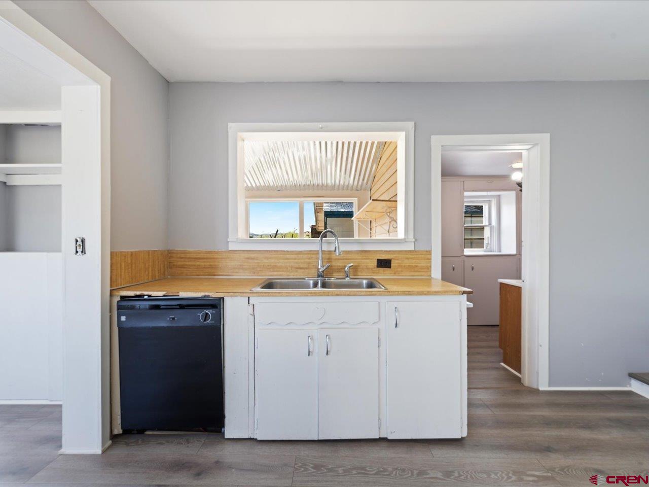 35826 Highway 145 Redvale, CO 81431 - Photo 7 of 22 a view of a kitchen with a sink a window and wooden floor