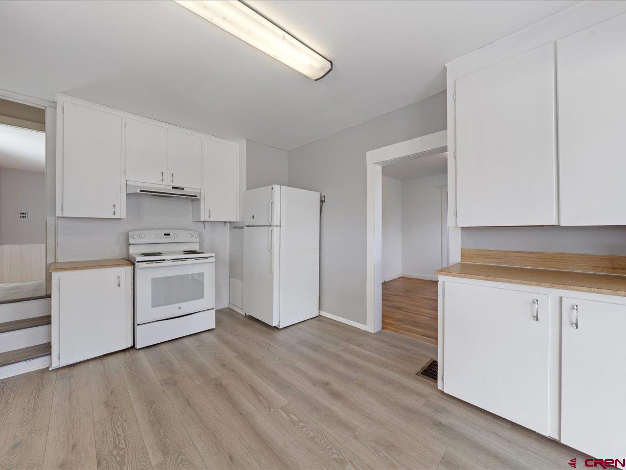 35826 Highway 145 Redvale, CO 81431 - Photo 8 of 22 a kitchen with white cabinets and white appliances