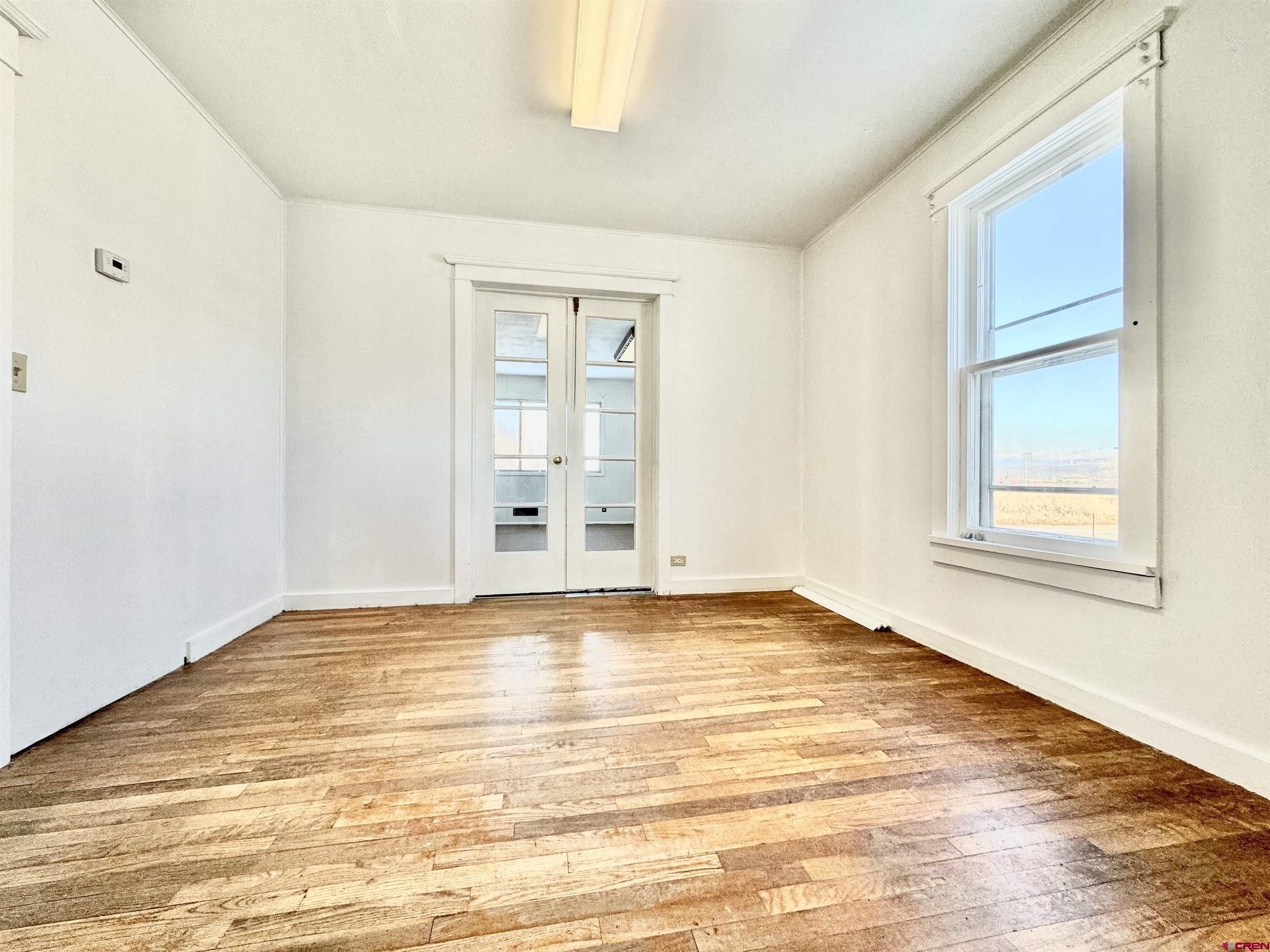 35826 Highway 145 Redvale, CO 81431 - Photo 10 of 22 a view of empty room with wooden floor and fan