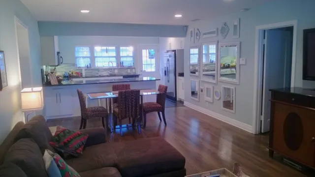 a view of a dining room with furniture and wooden floor