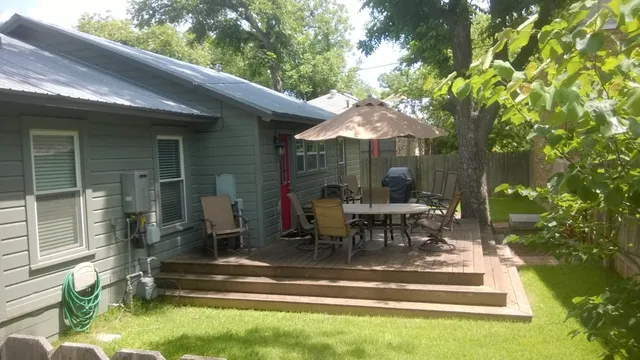 a view of a house with backyard porch and sitting area