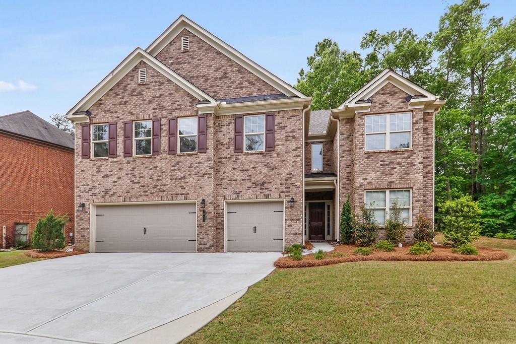 2015 Chapel Estates Lane Southeast Dacula, GA 30019 - Photo 1 of 1 a front view of a house with a yard and garage