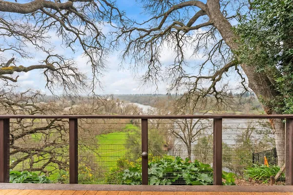 a view of a balcony with mountain view and wooden floor