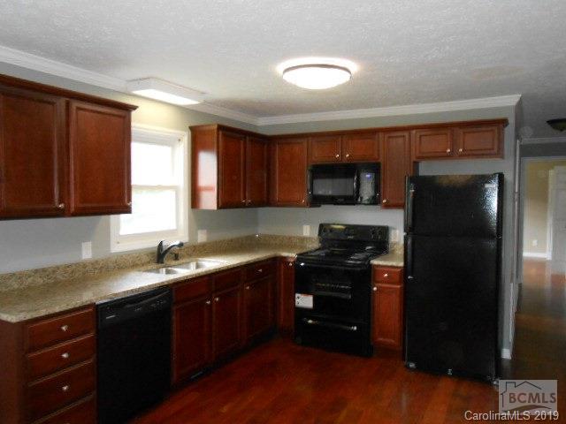 4808 Dentons Chapel Road Morganton, NC 28655 - Photo 16 of 20 a kitchen with a sink a stove a refrigerator and cabinets