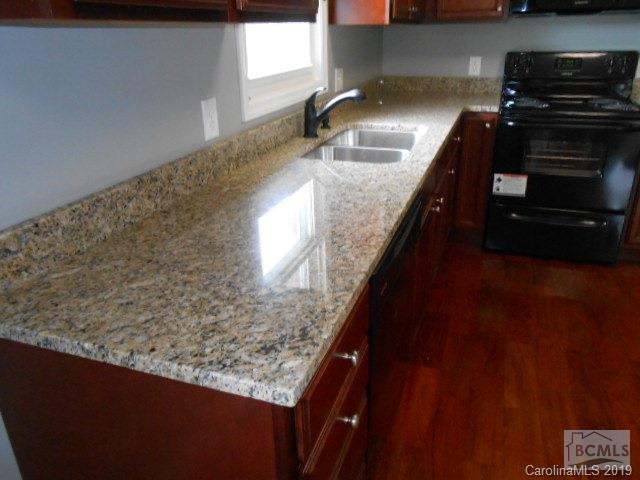 4808 Dentons Chapel Road Morganton, NC 28655 - Photo 18 of 20 a kitchen with granite countertop a sink and a stove