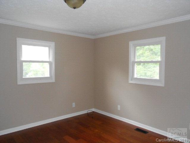 4808 Dentons Chapel Road Morganton, NC 28655 - Photo 5 of 20 a view of an empty room with wooden floor and a window