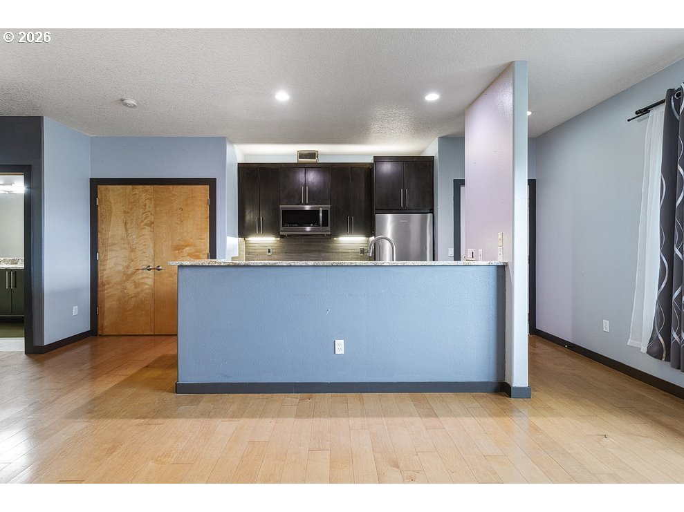 622 South Nevada Street, Unit D Portland, OR 97219 - Photo 13 of 37 a view of living room with stainless steel appliances kitchen island sink and refrigerator