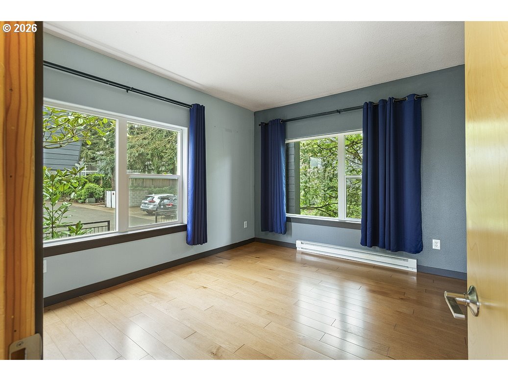 622 South Nevada Street, Unit D Portland, OR 97219 - Photo 20 of 37 a view of an empty room with wooden floor and a window