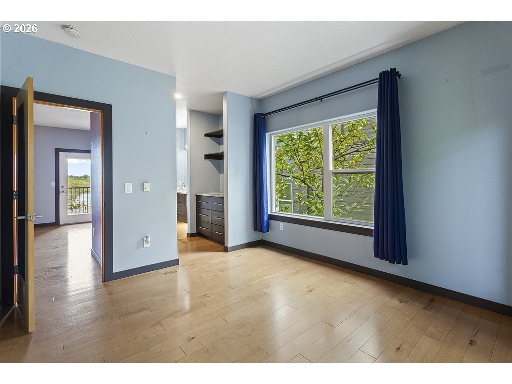 622 South Nevada Street, Unit D Portland, OR 97219 - Photo 21 of 37 a view of an empty room with window and wooden floor