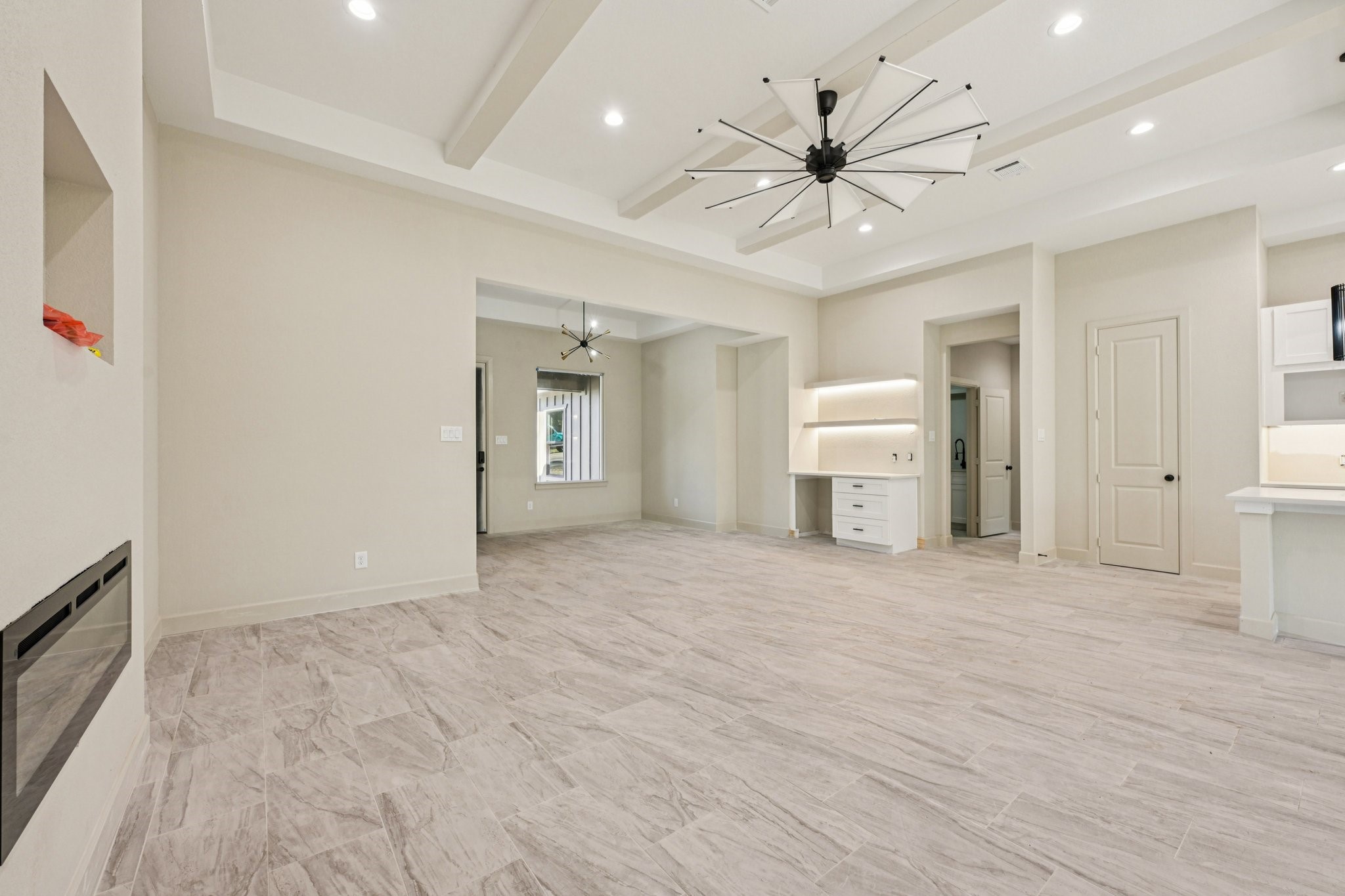 15132 Coaltown Road Willis, TX 77378 - Photo 5 of 29 s living area features modern tile flooring, recessed lighting, and a contemporary Another view of the living area showing the coffee space, ceiling fan. and great open layout.