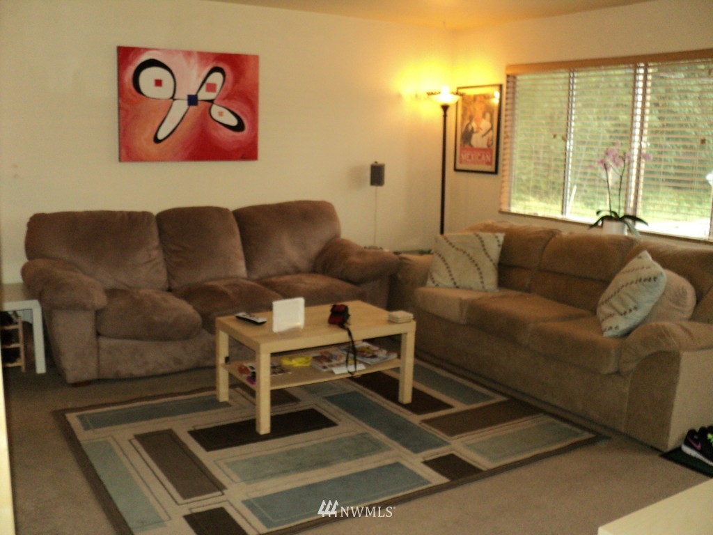 24302 Carter Road Bothell, WA 98021 - Photo 7 of 10 a living room with furniture a large window and a flat screen tv