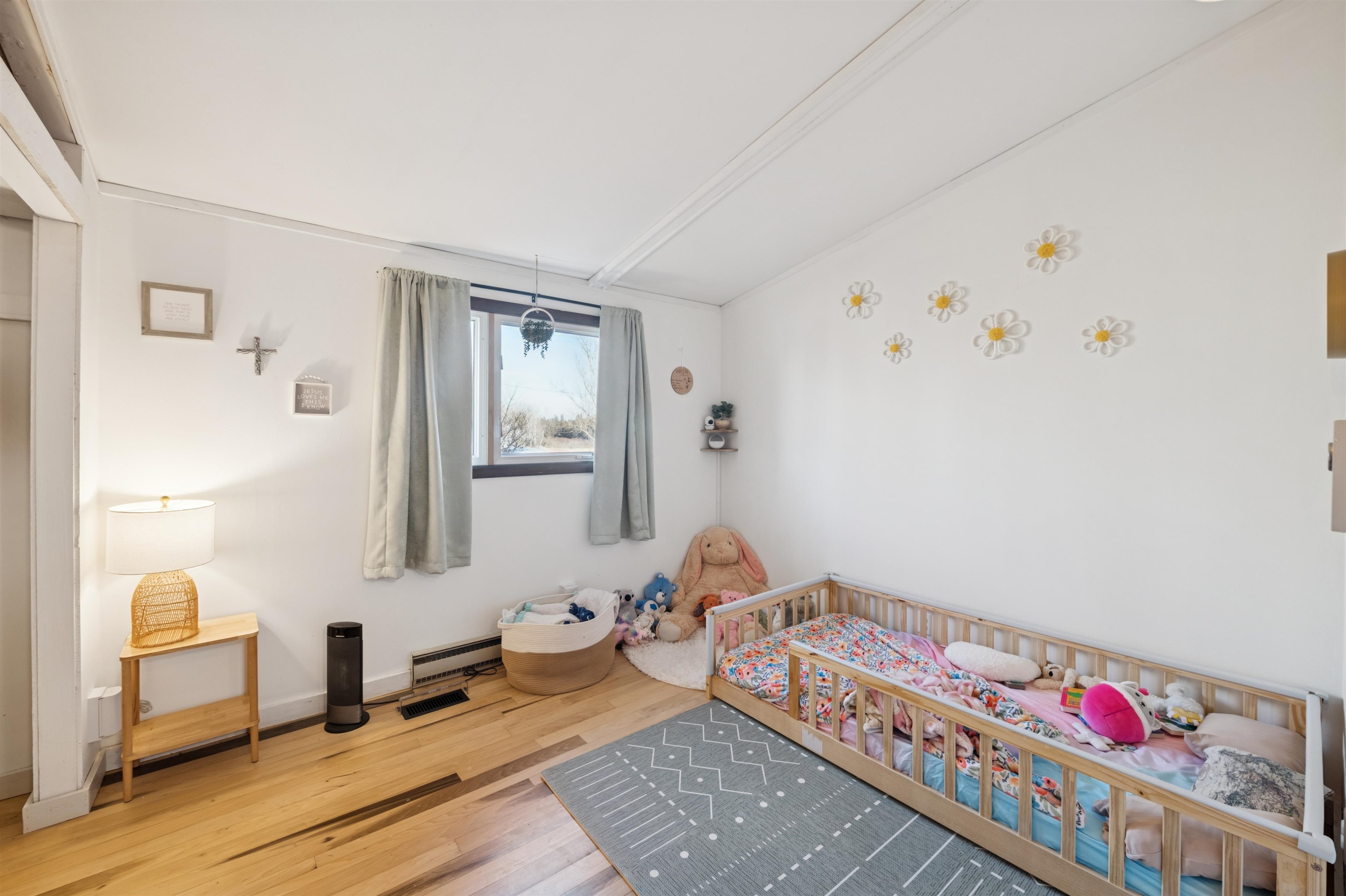 19805 Keystone Road Mason, WI 54856 - Photo 16 of 25 Bedroom featuring wood finished floors, a nursery area, and a baseboard heating unit