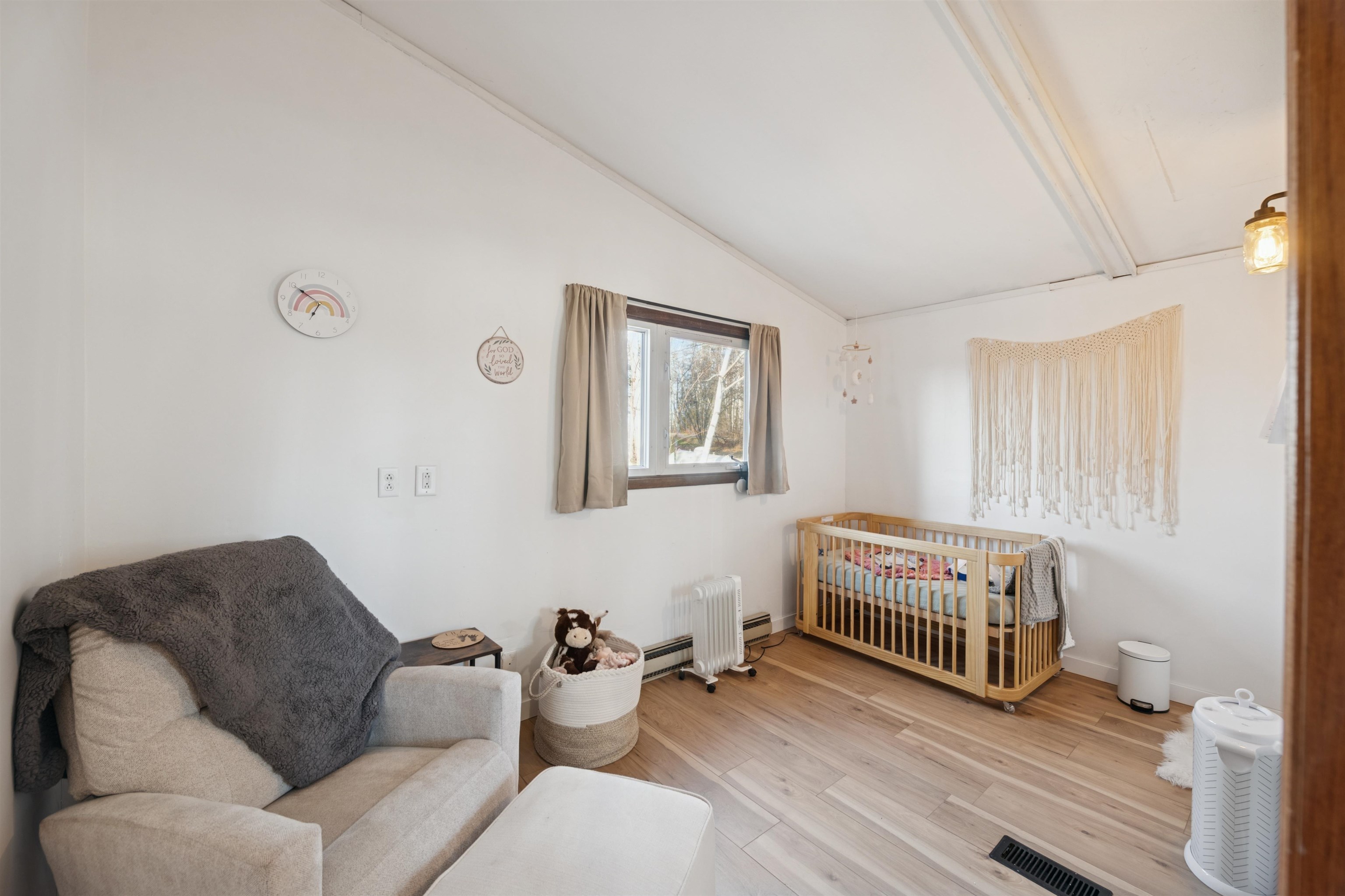 19805 Keystone Road Mason, WI 54856 - Photo 17 of 25 Bedroom with a crib, lofted ceiling, and light wood finished floors