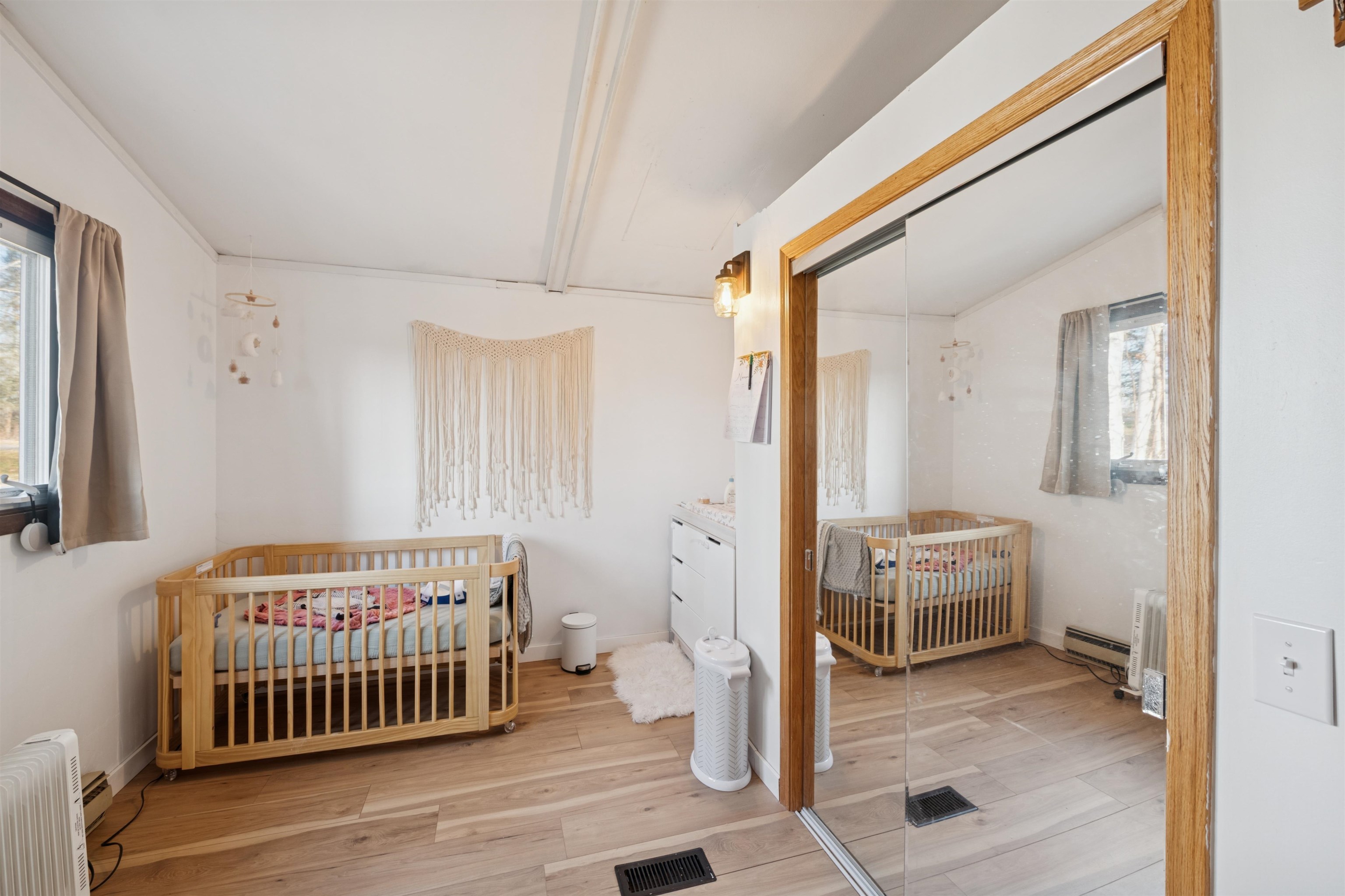 19805 Keystone Road Mason, WI 54856 - Photo 18 of 25 Bedroom with a crib, light wood-style flooring, a closet, and radiator