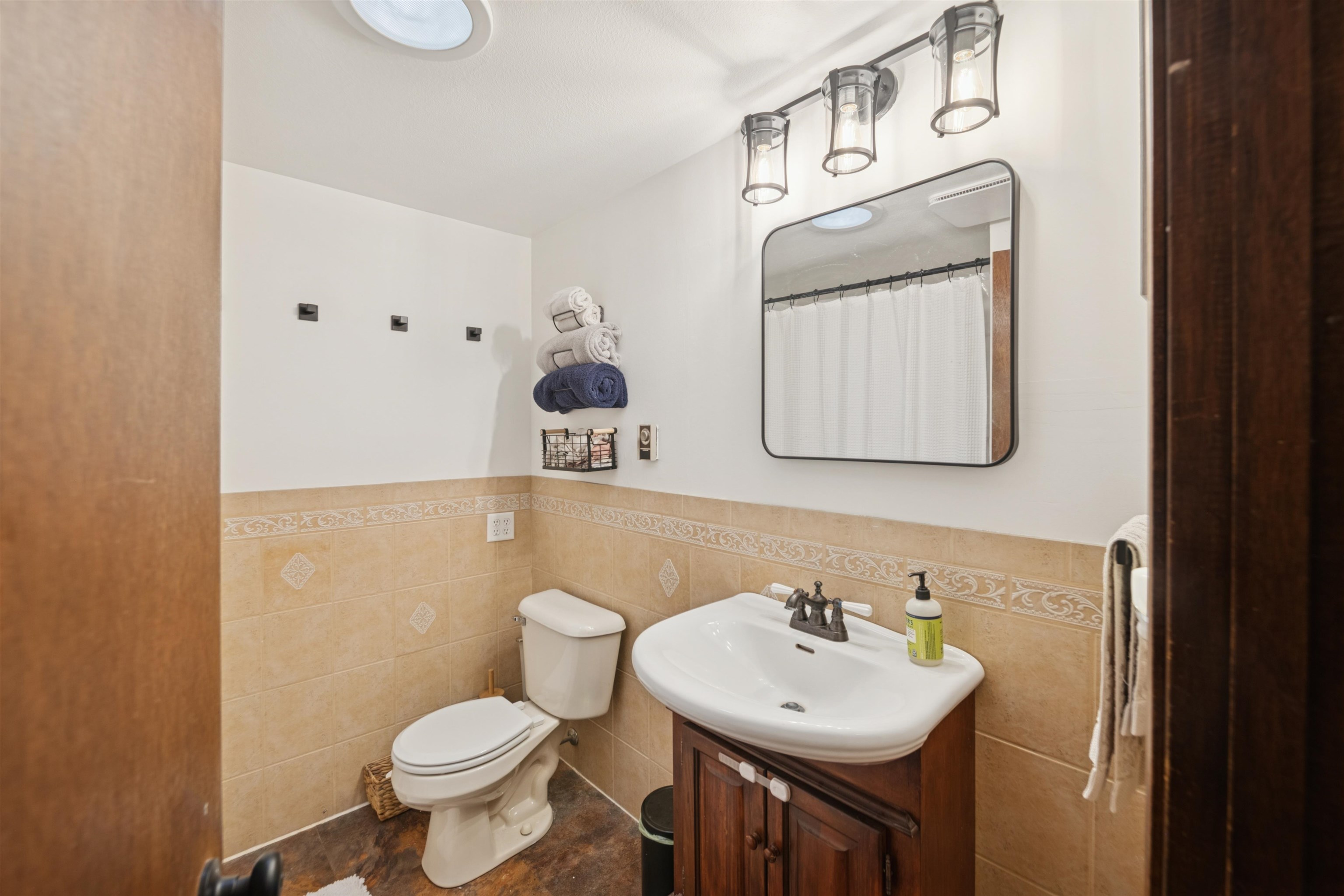 19805 Keystone Road Mason, WI 54856 - Photo 19 of 25 Full bathroom with vanity, a shower with shower curtain, tile walls, and a wainscoted wall