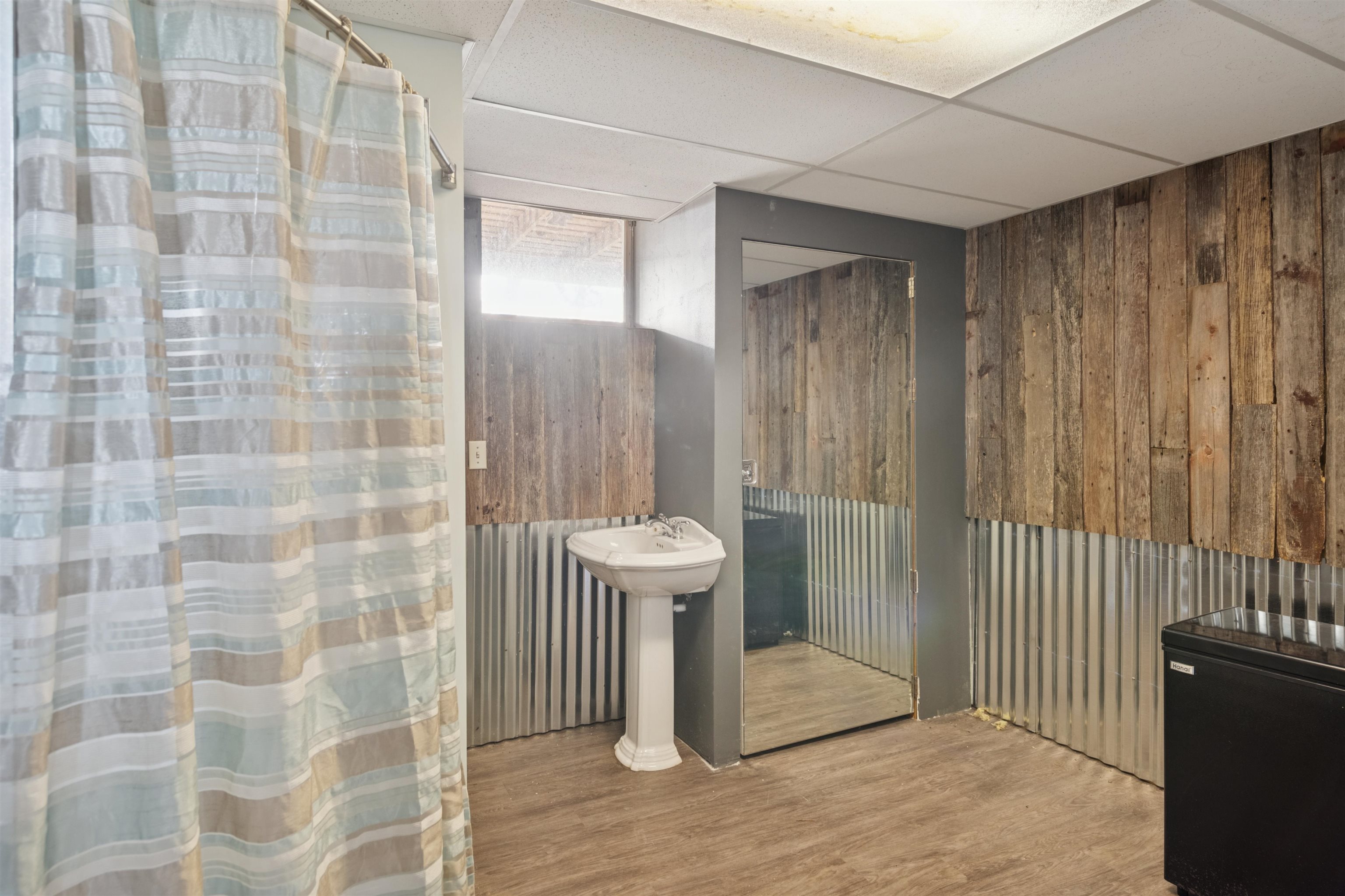 19805 Keystone Road Mason, WI 54856 - Photo 20 of 25 Full bath featuring a paneled ceiling, wooden walls, a shower with shower curtain, and wood finished floors
