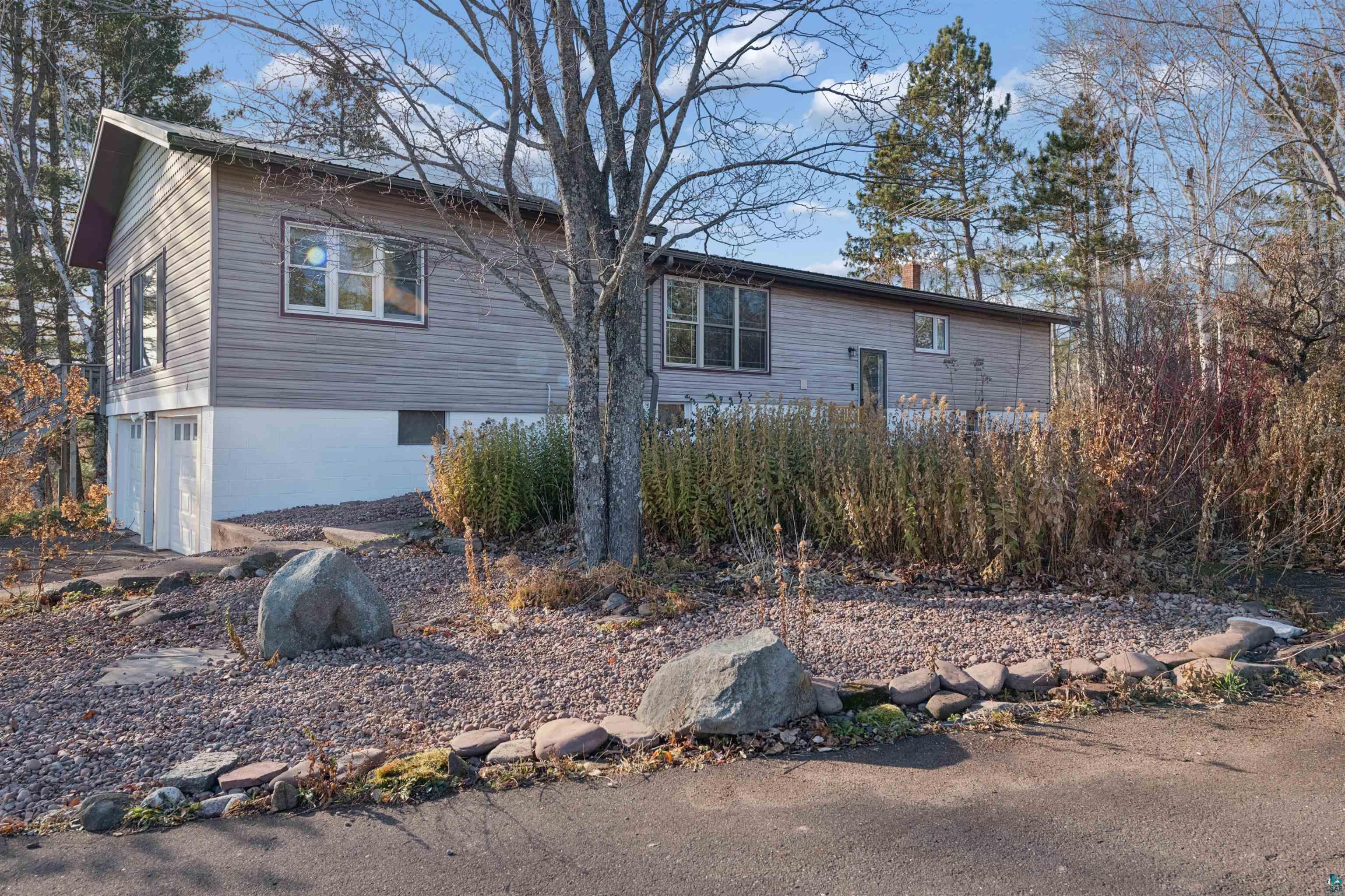 19805 Keystone Road Mason, WI 54856 - Photo 2 of 25 View of home's exterior with a chimney and an attached garage