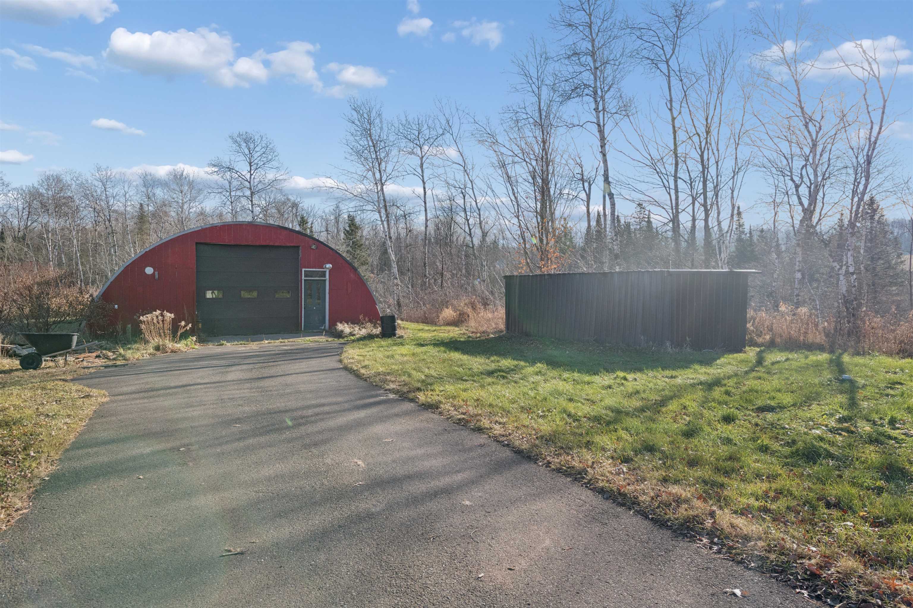 19805 Keystone Road Mason, WI 54856 - Photo 22 of 25 View of pole building with asphalt driveway and a yard