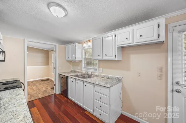 a kitchen with cabinets appliances and a wooden floor