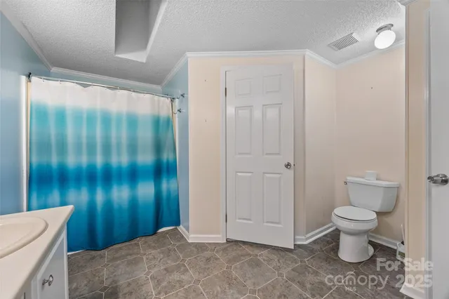 a bathroom with a toilet sink and shower