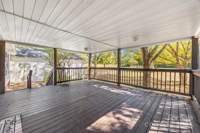 a view of hallway with wooden floor