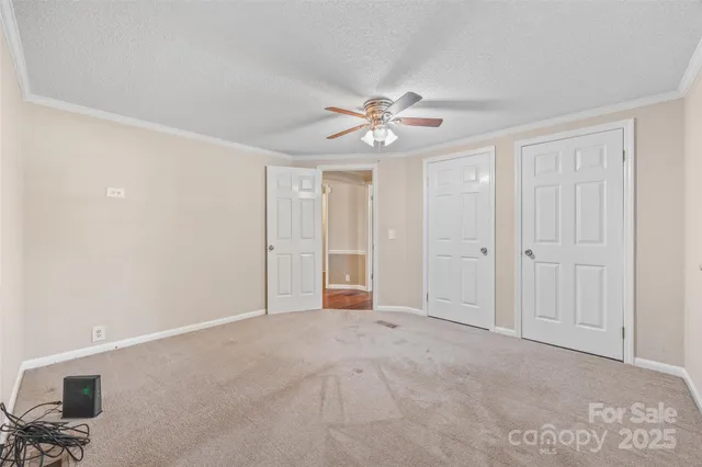 a view of an empty room with a ceiling fan