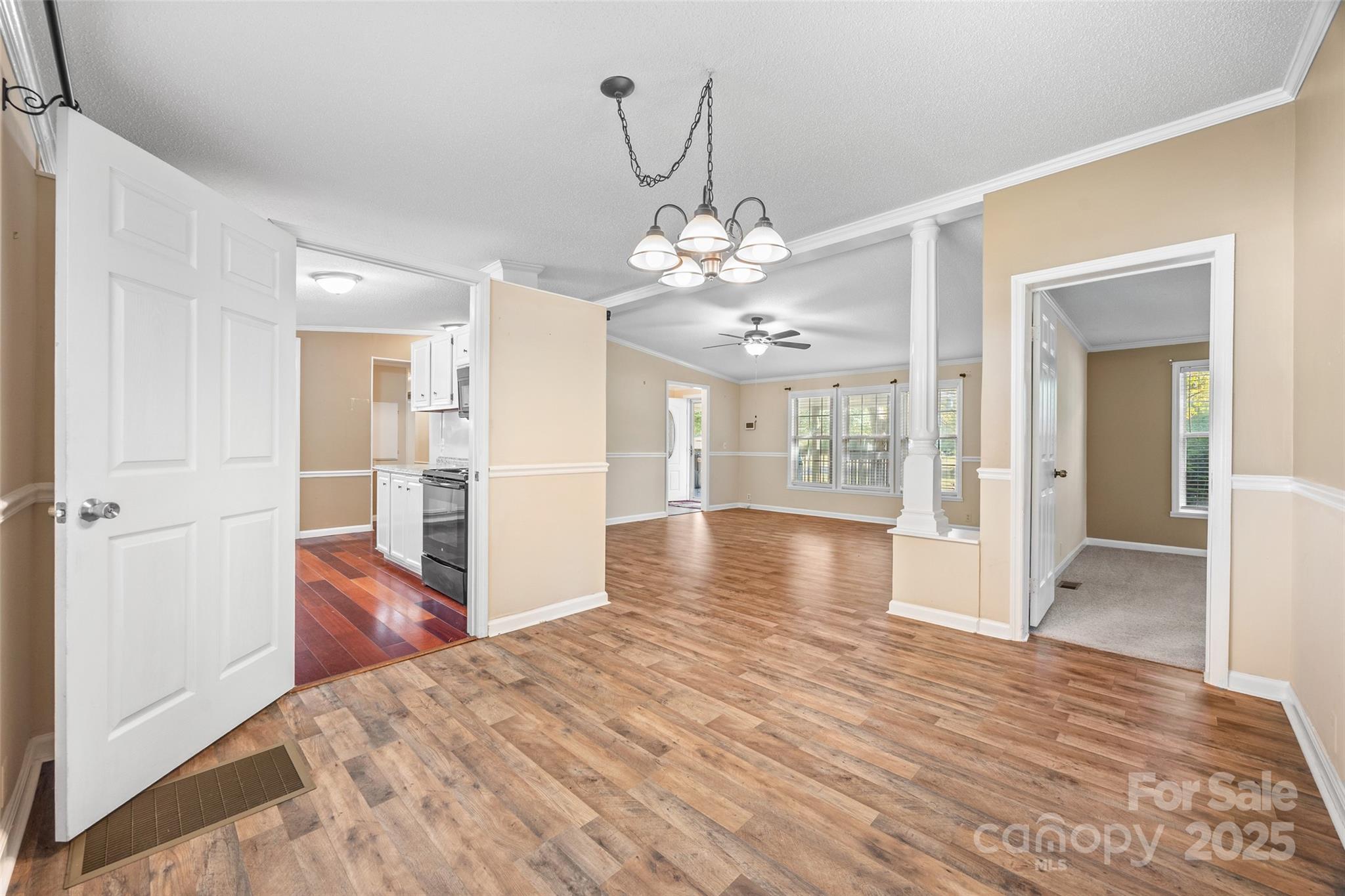 4640 Mel Nunnery Road Fort Lawn, SC 29714 - Photo 9 of 37 a view of a hallway with wooden floor and a chandelier