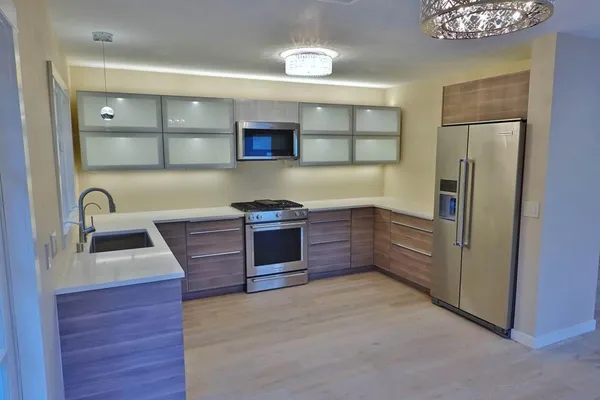 a stove top oven sitting inside of a kitchen