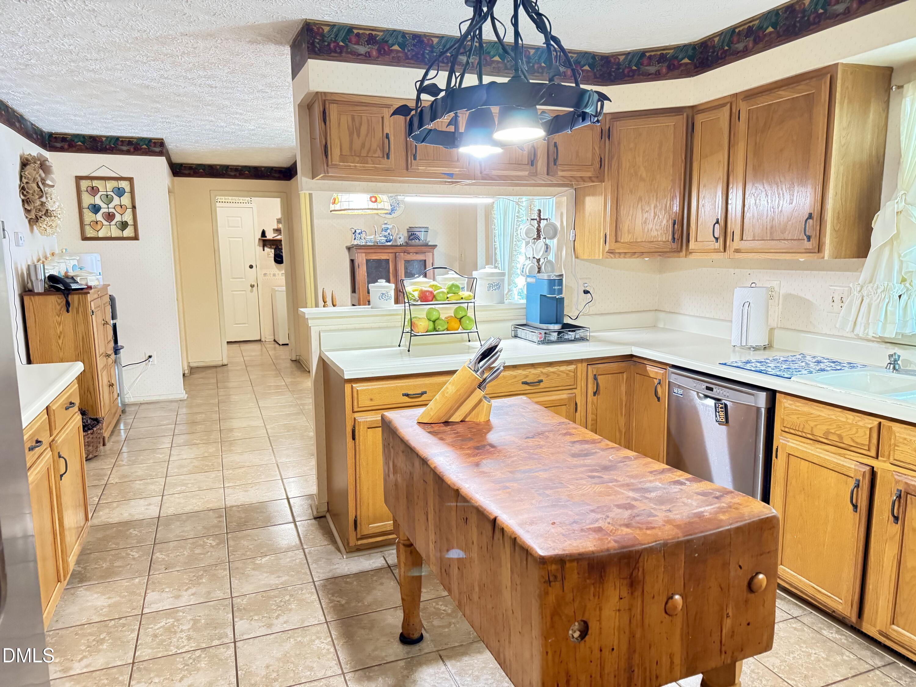 84 Wintergreen Road Henderson, NC 27537 - Photo 9 of 49 a kitchen with stainless steel appliances kitchen island granite countertop a sink and cabinets
