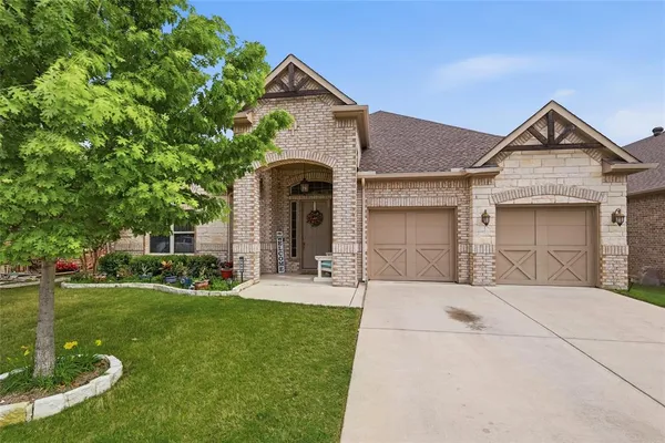 a front view of a house with a yard garage and outdoor seating