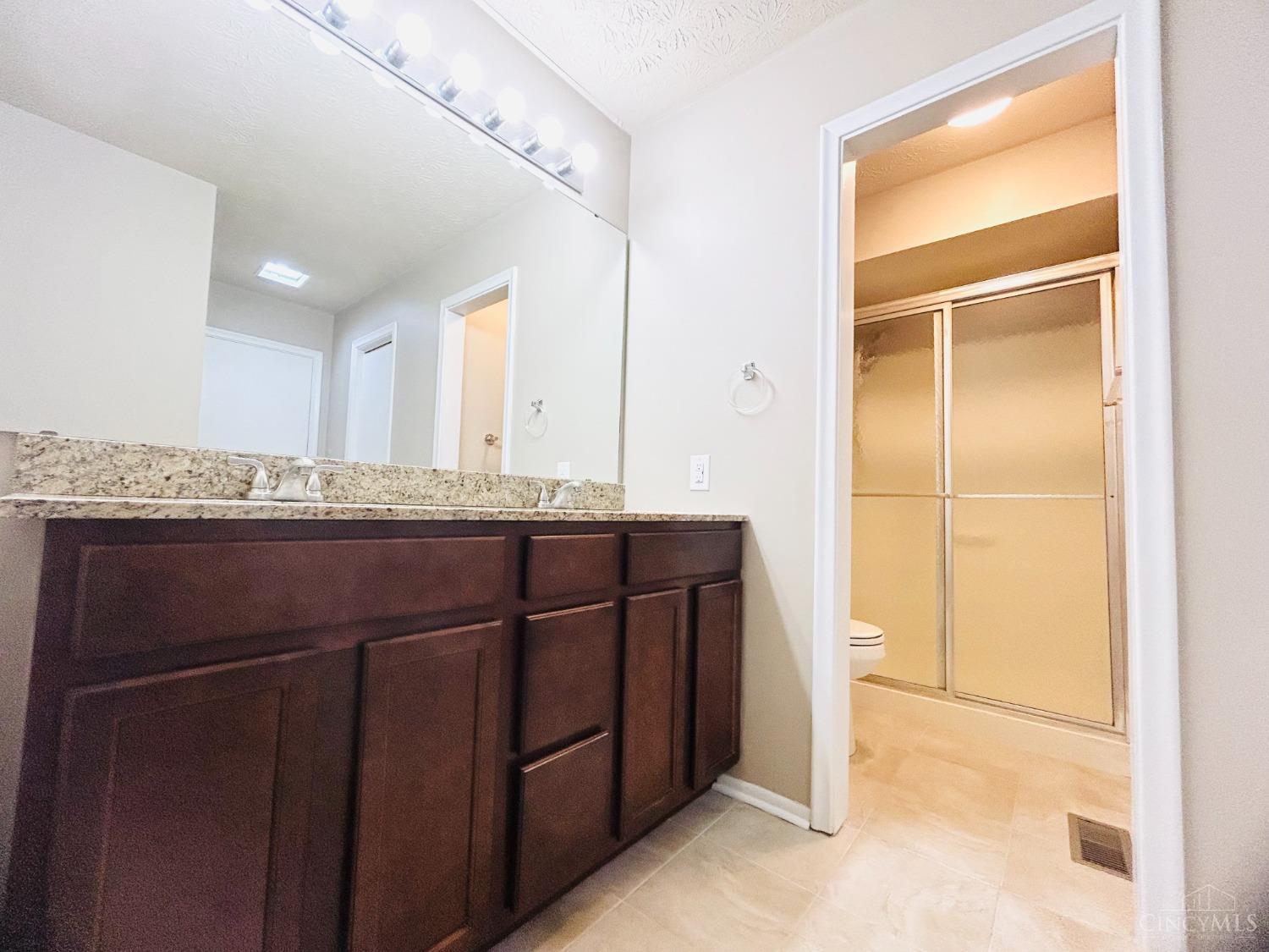 8122 Timbertree Way Beckett Ridge, OH 45069 - Photo 15 of 36 Full master bathroom recently upgraded with tile floor, double sinks vanity with granite countertop.