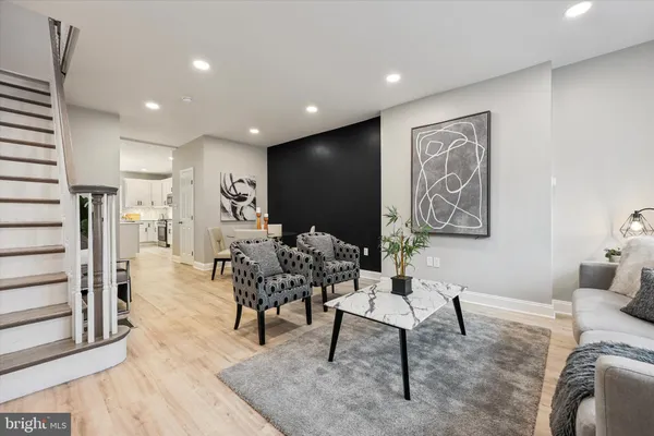 a living room with furniture and a painting on the wall