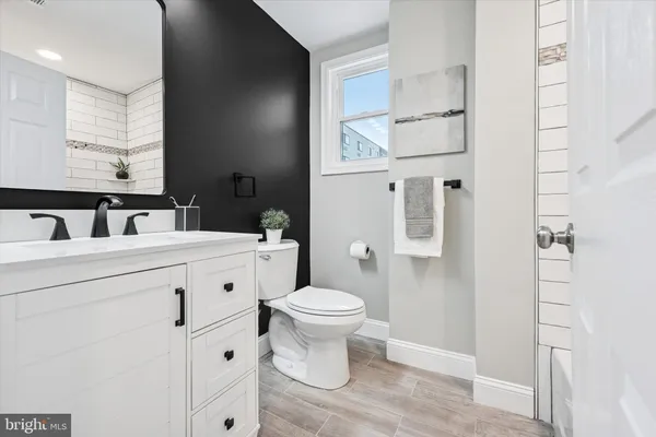 a bathroom with a toilet sink and mirror