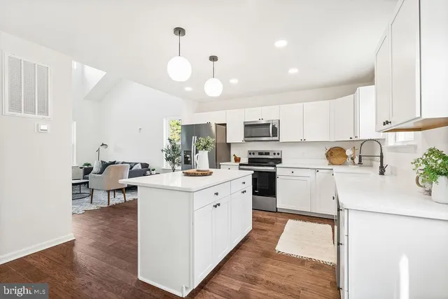 a kitchen with white cabinets and white appliances