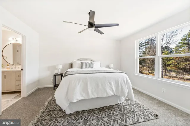 a bedroom with a bed and a chair