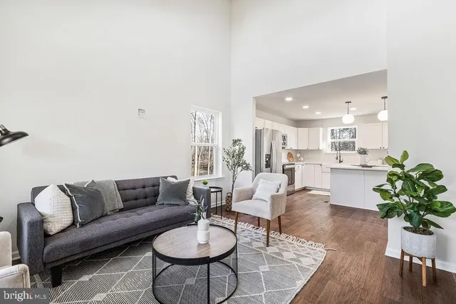 a living room with furniture kitchen view and a table
