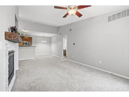 a kitchen with stainless steel appliances kitchen island granite countertop a stove a sink and a refrigerator