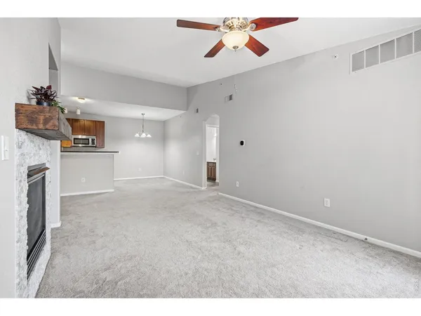 a kitchen with stainless steel appliances kitchen island granite countertop a stove a sink and a refrigerator