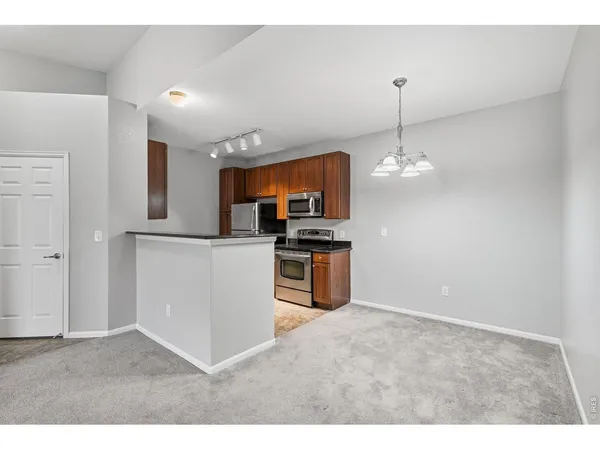 a kitchen with kitchen island granite countertop stainless steel appliances a sink cabinets and a counter top