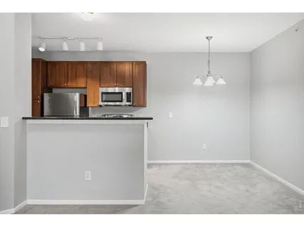 a kitchen with stainless steel appliances a microwave a sink and a refrigerator
