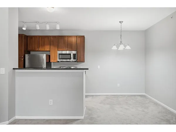 a kitchen with stainless steel appliances a microwave a sink and a refrigerator