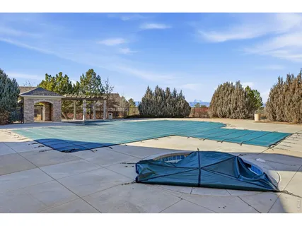 a view of a swimming pool with an outdoor space and seating area