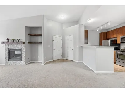 a view of an empty room with a kitchen